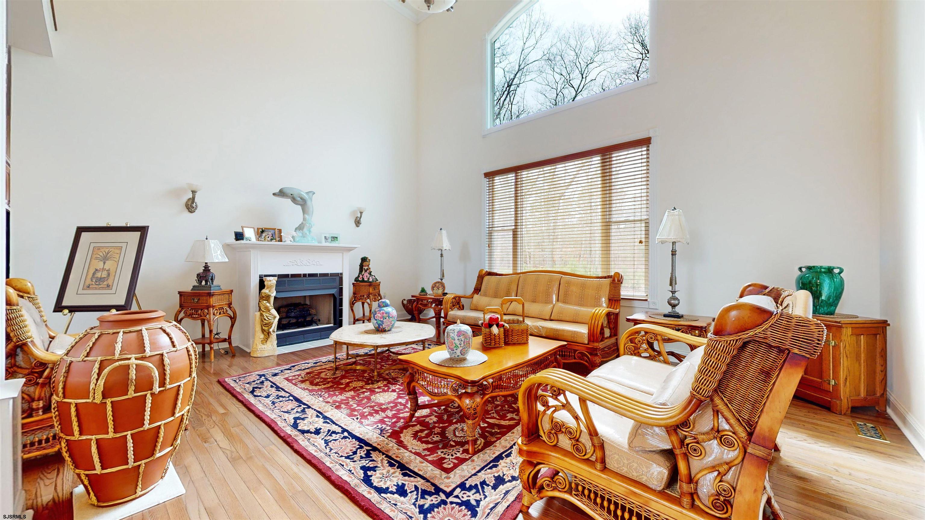 33 North New York Road Smithville, NJ 08205 - Photo 13 of 53 a living room with furniture a fireplace and a table