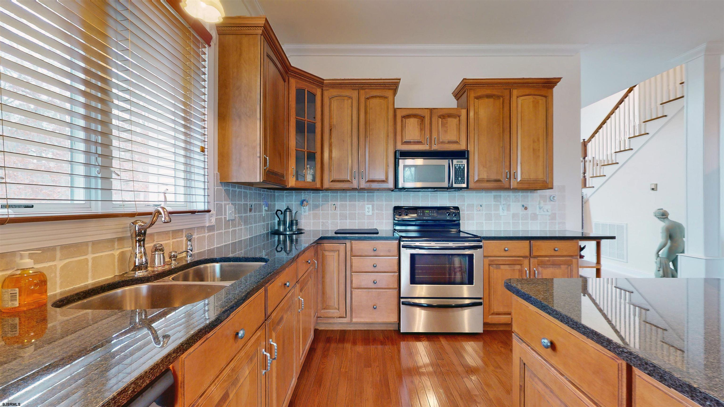 33 North New York Road Smithville, NJ 08205 - Photo 16 of 53 a kitchen with stainless steel appliances a stove a sink and a microwave