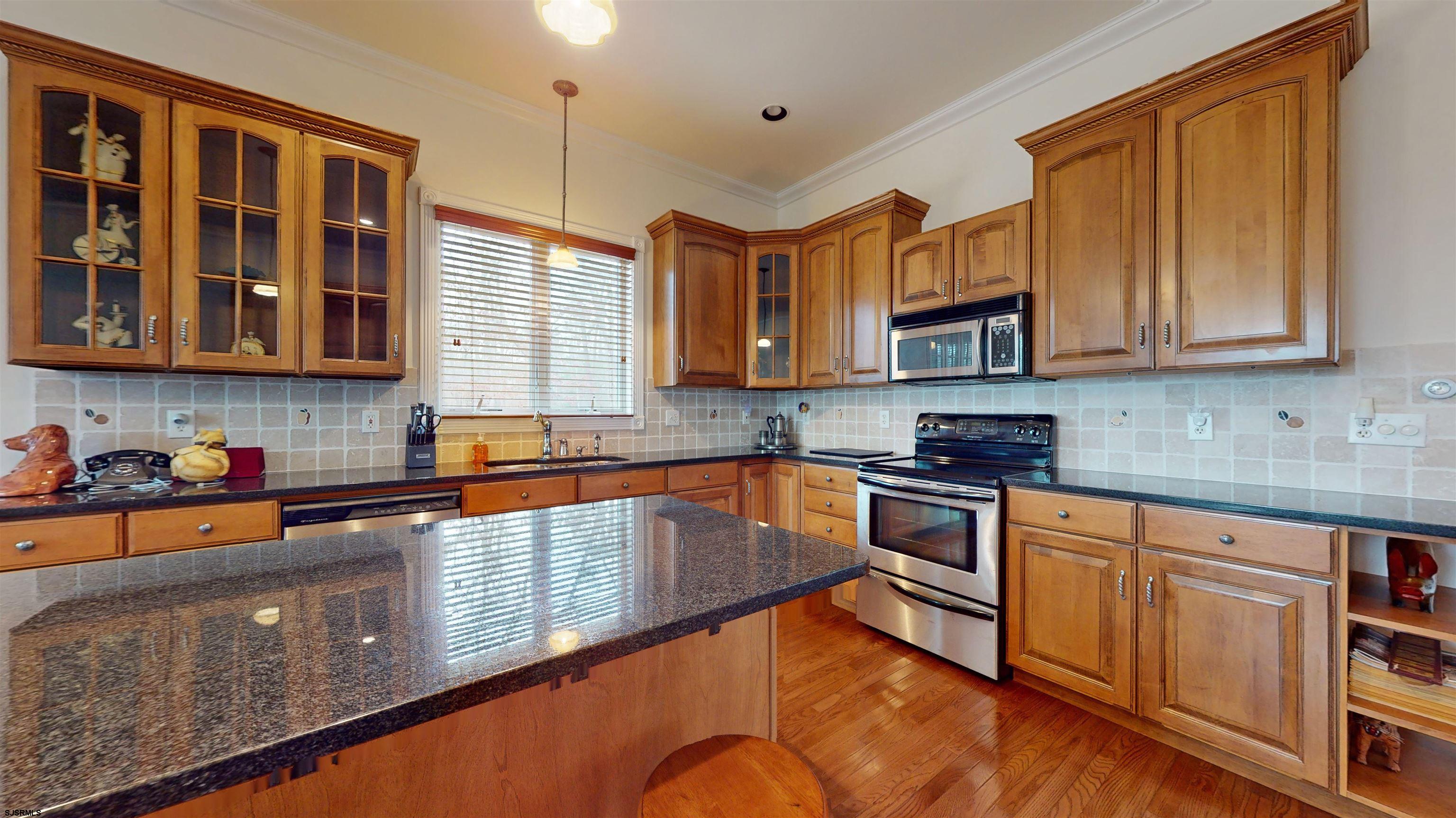 33 North New York Road Smithville, NJ 08205 - Photo 17 of 53 a kitchen with stainless steel appliances granite countertop a stove sink and cabinets