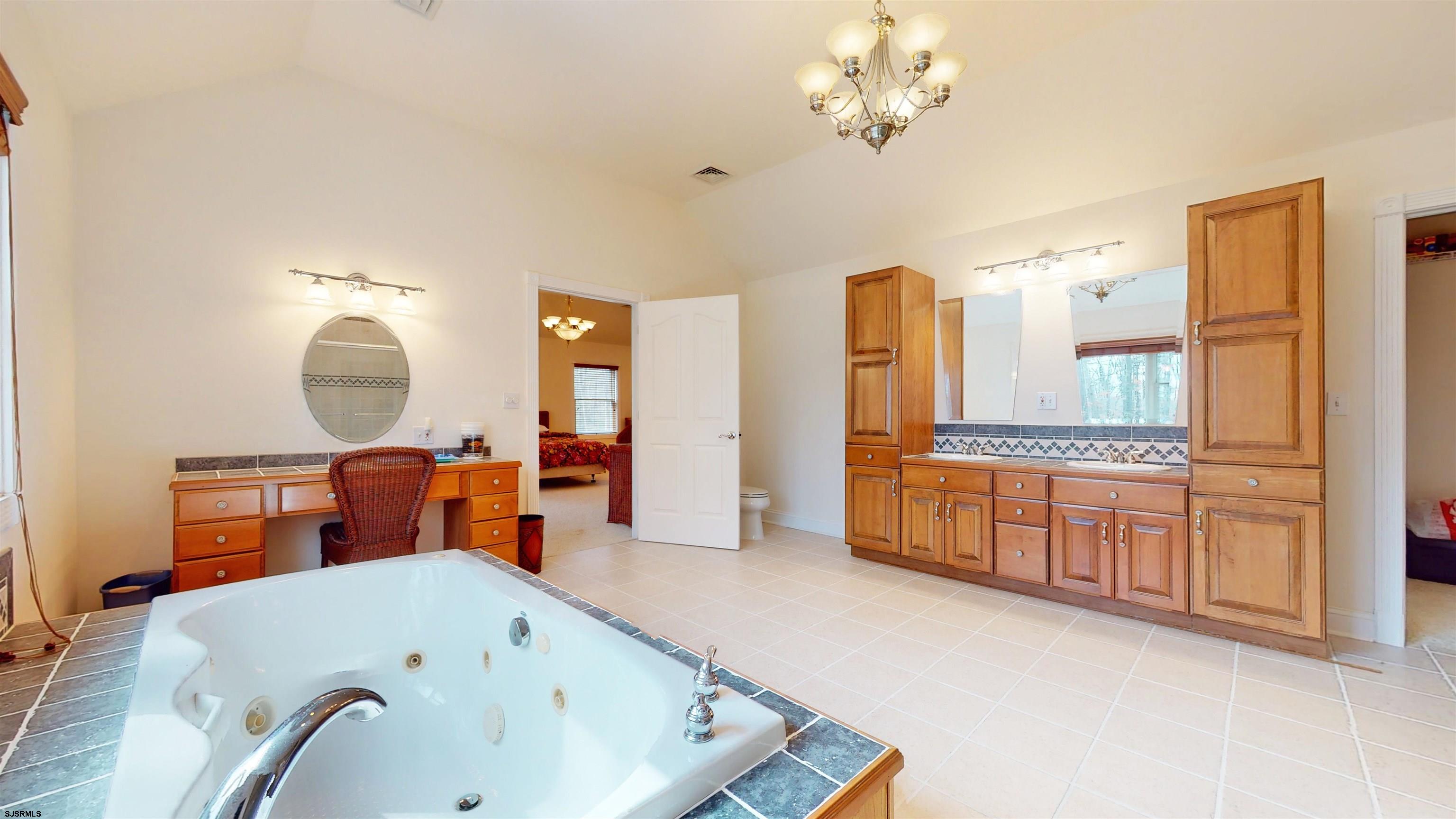 33 North New York Road Smithville, NJ 08205 - Photo 31 of 53 a bathroom with a tub sink and mirror