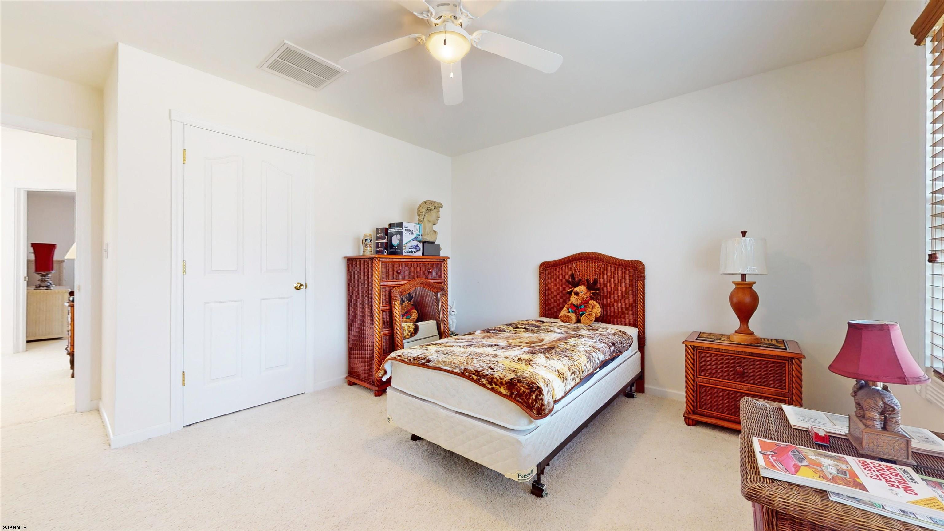 33 North New York Road Smithville, NJ 08205 - Photo 35 of 53 a bedroom with a bed and a chandelier fan