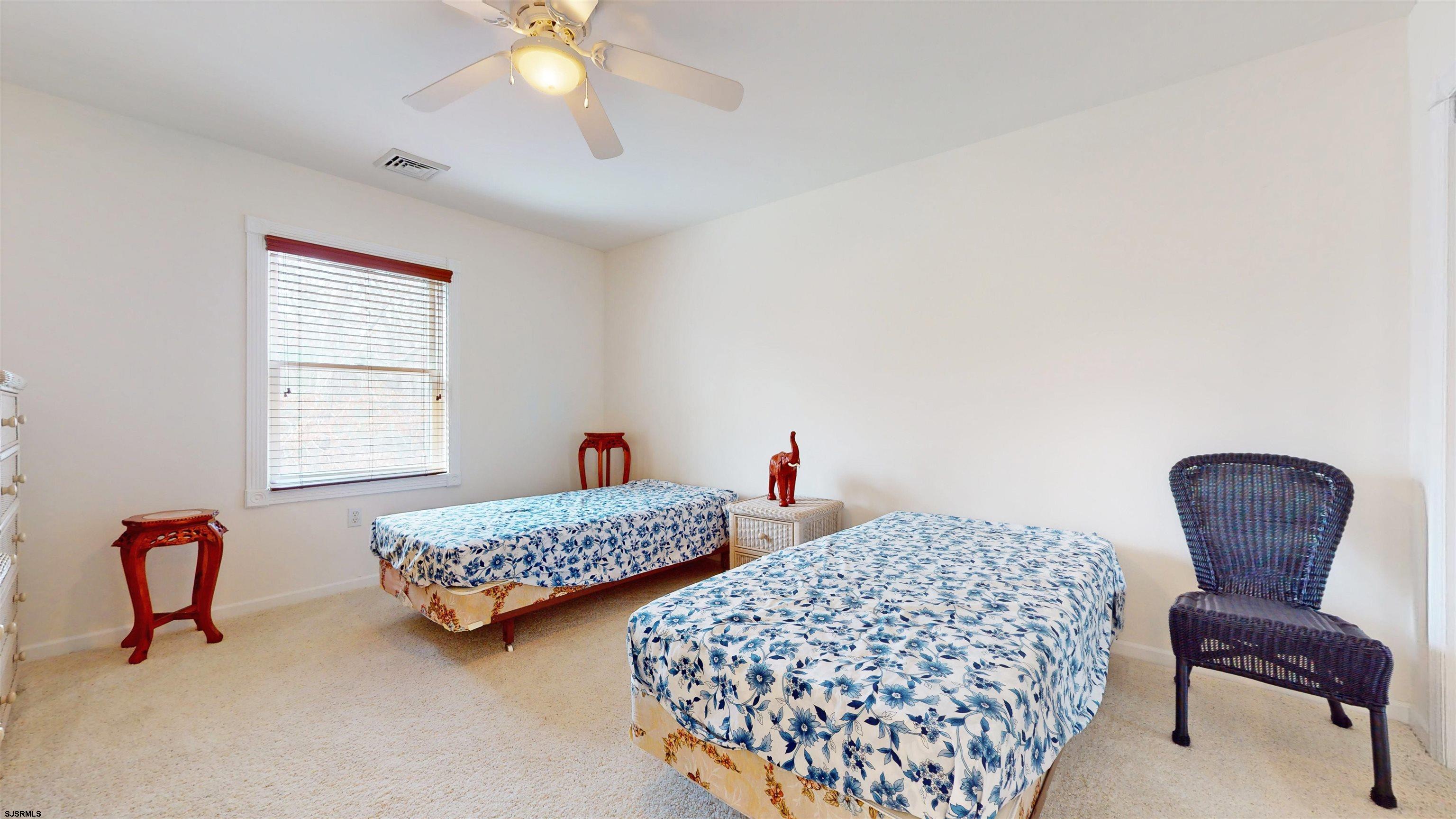 33 North New York Road Smithville, NJ 08205 - Photo 36 of 53 a bedroom with two beds and chair