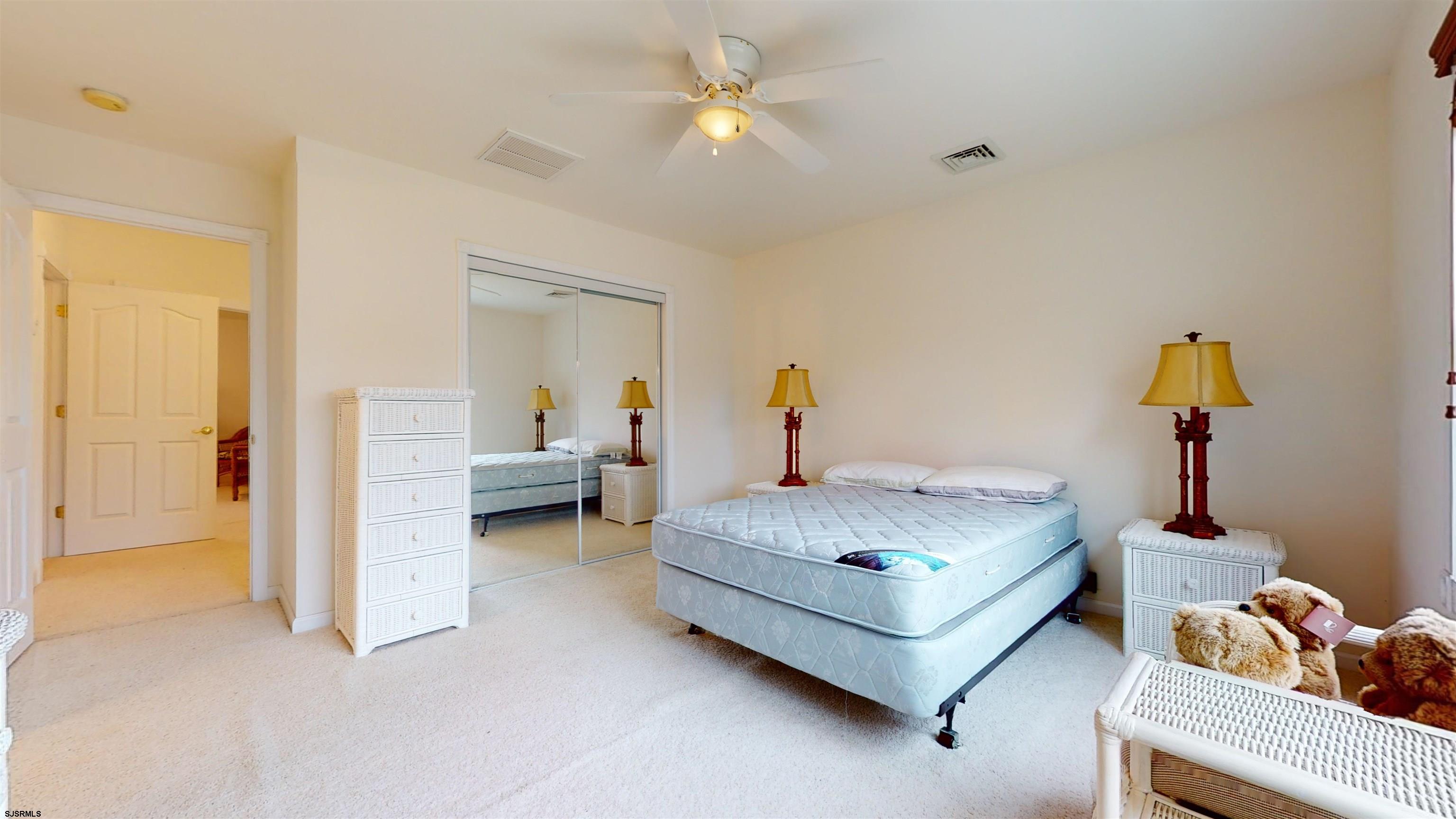 33 North New York Road Smithville, NJ 08205 - Photo 38 of 53 a bedroom with bed and a chandelier