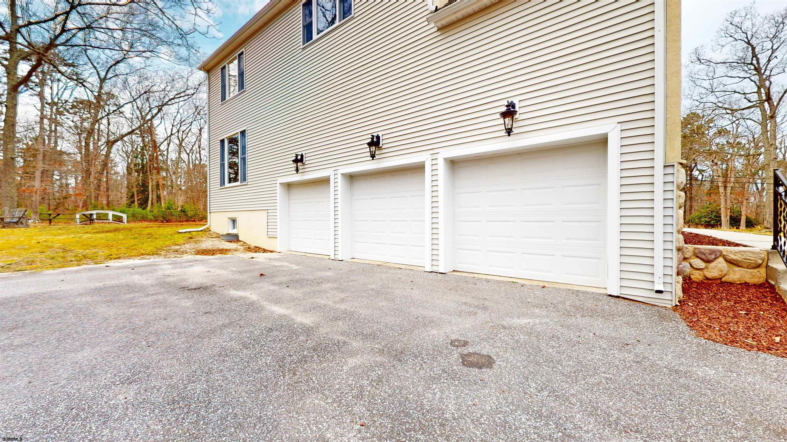 33 North New York Road Smithville, NJ 08205 - Photo 7 of 53 a view of the house with a yard and garage
