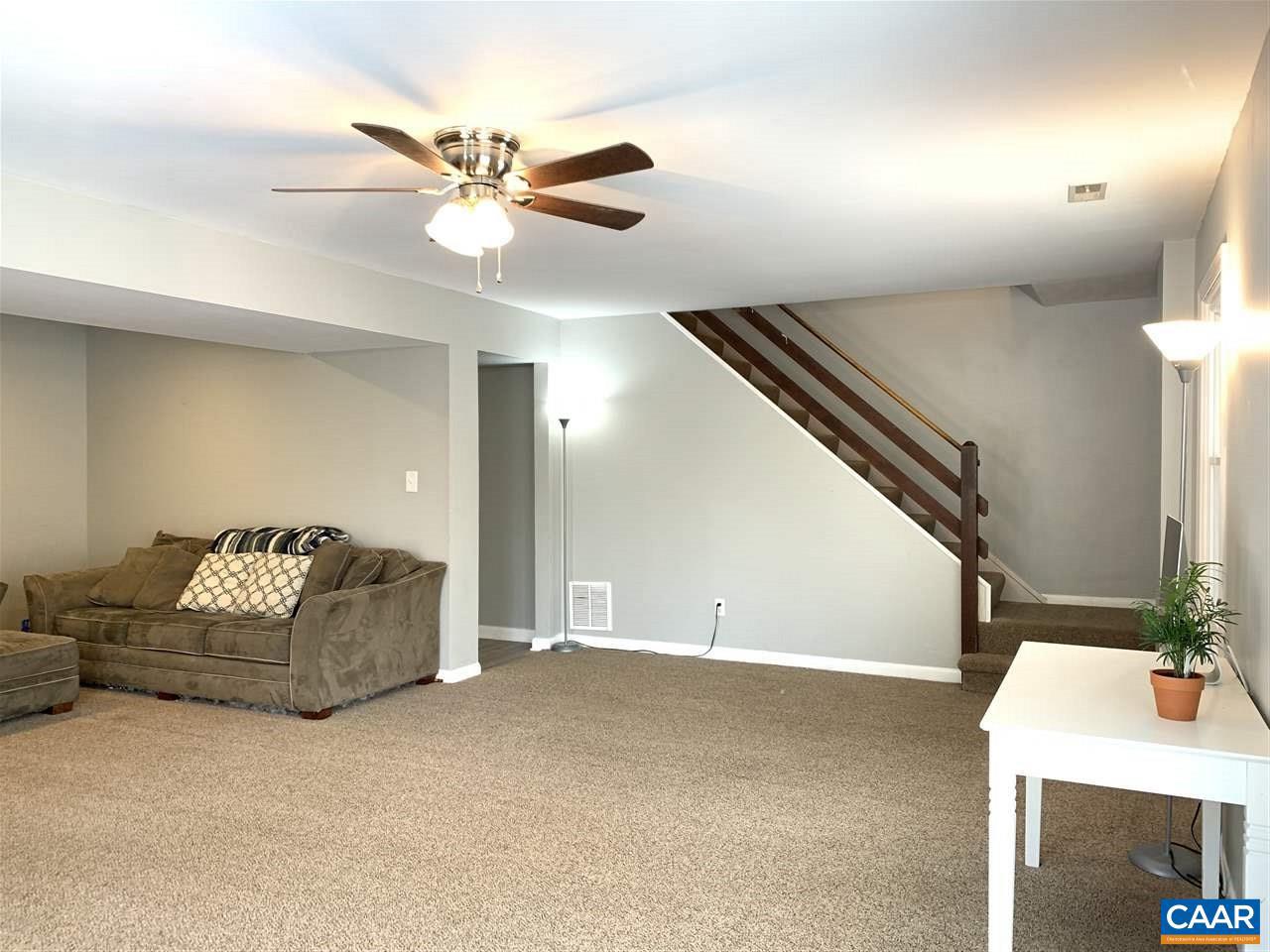 4354 Dickerson Road Charlottesville, VA 22911 - Photo 17 of 29 a living room with furniture and a chandelier