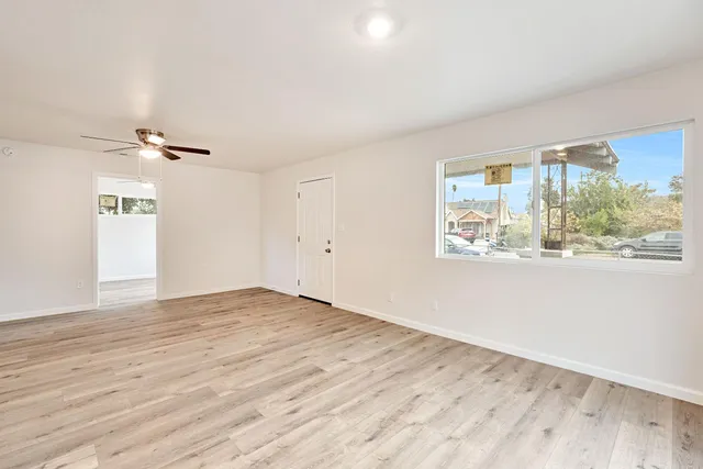 a view of a room with wooden floor and window