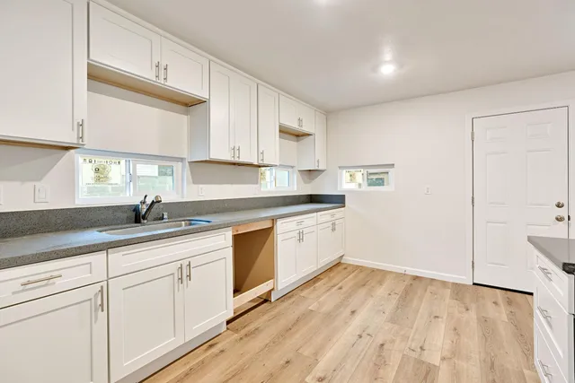 a kitchen with a sink stove and cabinets