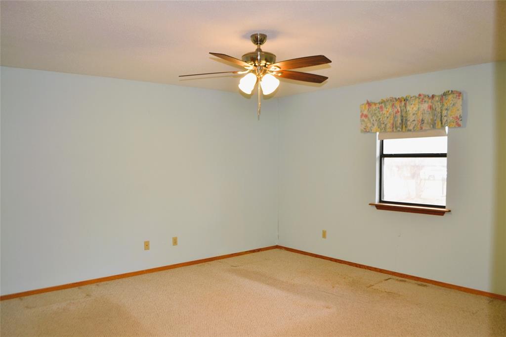 213 County Road 1997 Yantis, TX 75497 - Photo 18 of 38 an empty room with windows and fan