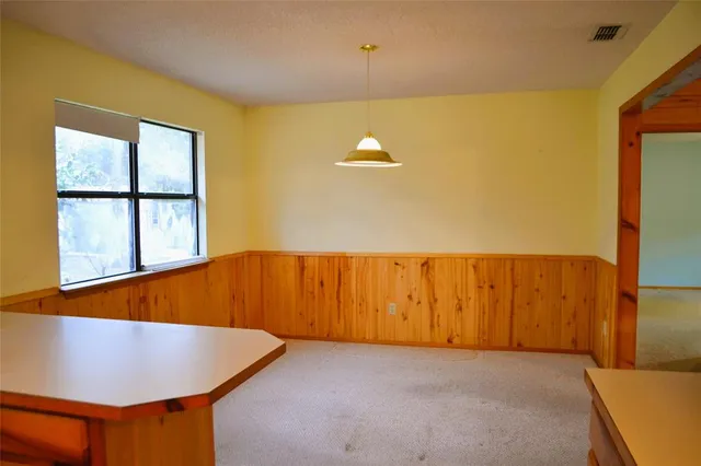 a view of a room with a window and a ceiling fan