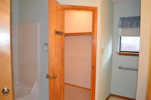 a bathroom with a granite countertop sink a toilet and a shower