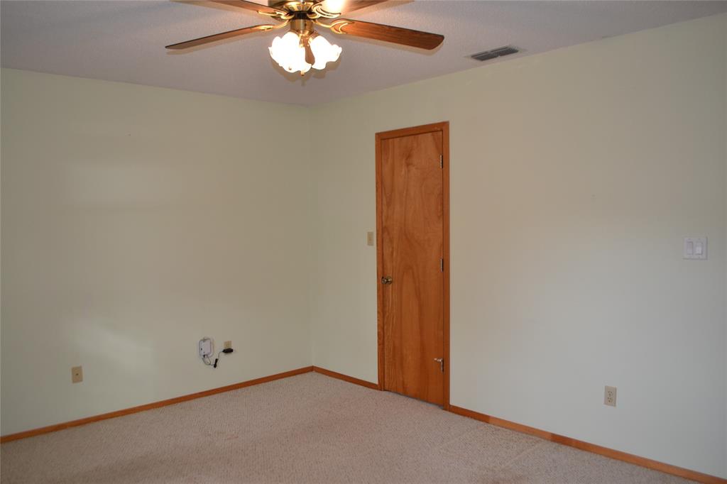 213 County Road 1997 Yantis, TX 75497 - Photo 25 of 38 an empty room with a chandelier fan