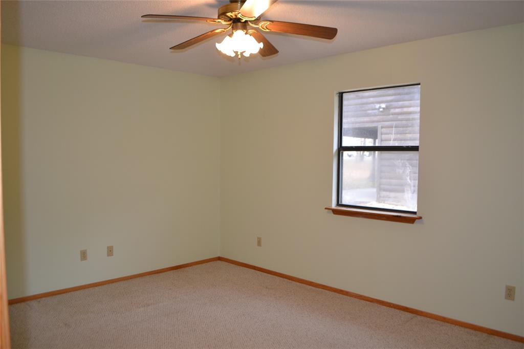213 County Road 1997 Yantis, TX 75497 - Photo 30 of 39 an empty room with windows and fan
