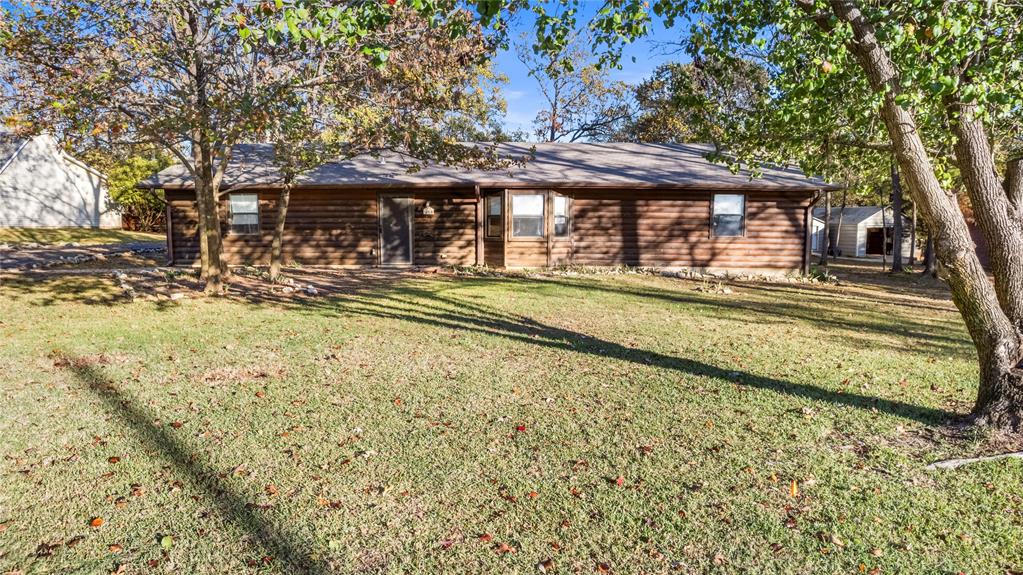 213 County Road 1997 Yantis, TX 75497 - Photo 5 of 39 a view of a house with a yard patio and deck