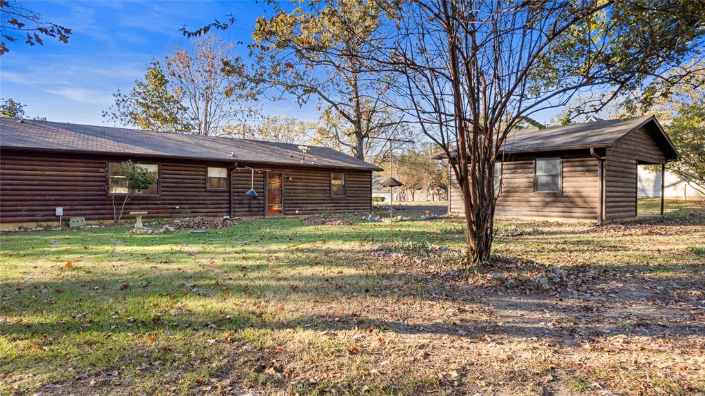 213 County Road 1997 Yantis, TX 75497 - Photo 6 of 39 a view of a backyard with a large tree