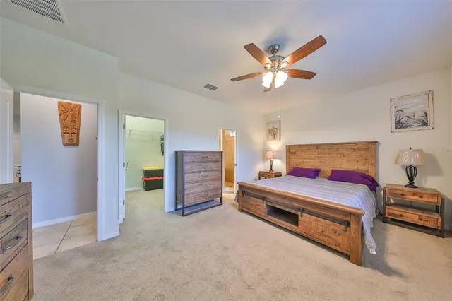 a bedroom with furniture and a ceiling fan