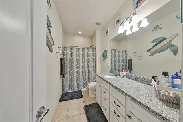 a bathroom with a double vanity sink mirror and shower