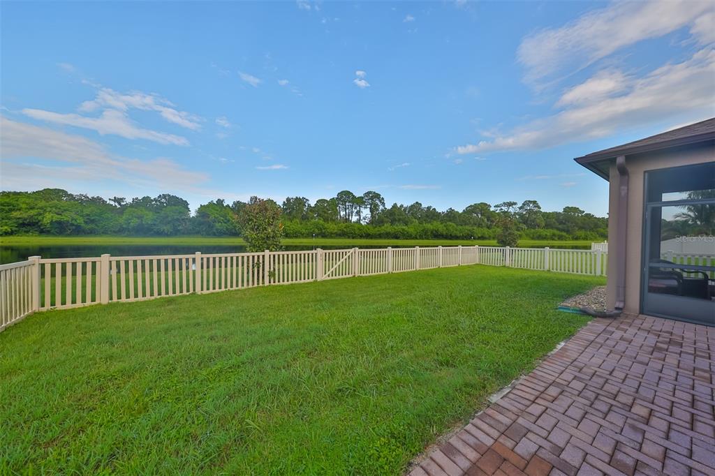 1606 Cabbage Key Drive Ruskin, FL 33570 - Photo 16 of 31 a view of a green field with wooden fence