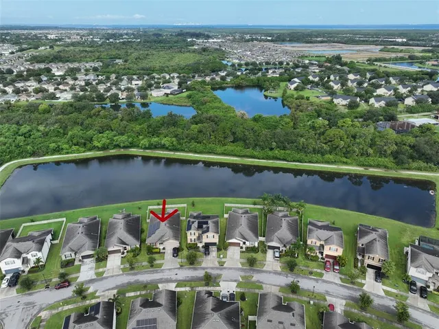 an aerial view of a house with outdoor space