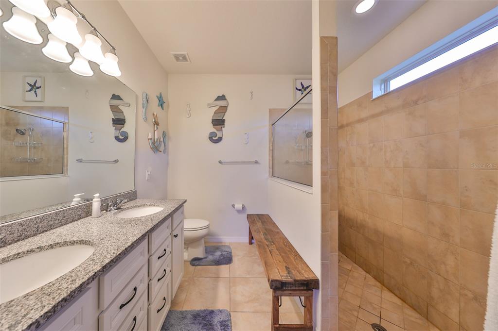 1606 Cabbage Key Drive Ruskin, FL 33570 - Photo 24 of 31 a bathroom with a granite countertop sink toilet and shower