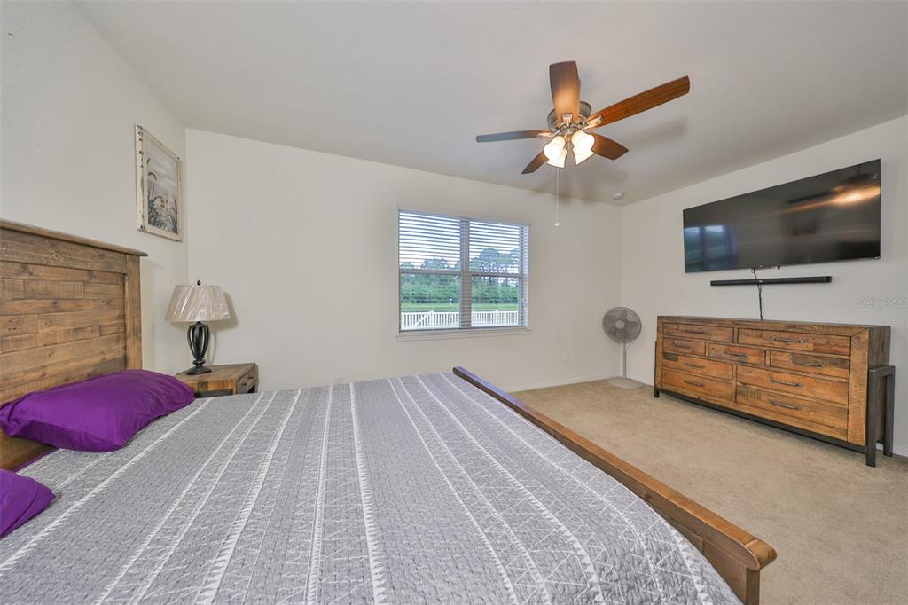 1606 Cabbage Key Drive Ruskin, FL 33570 - Photo 25 of 31 a bedroom with a bed and a flat screen tv