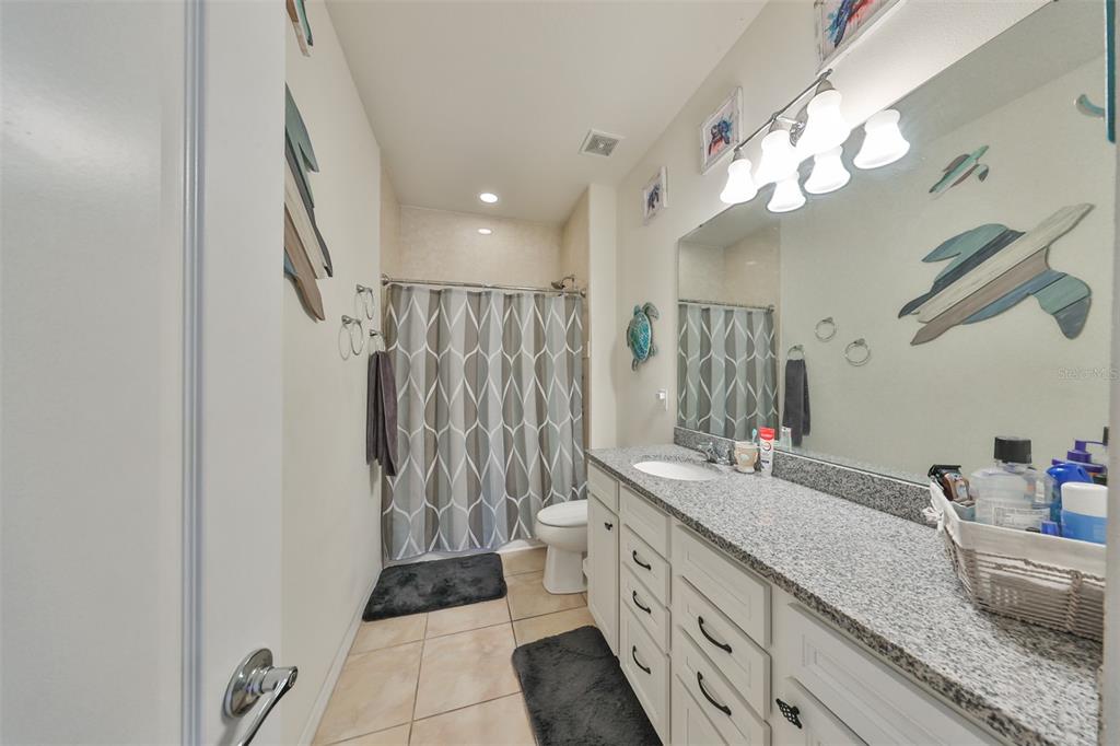 1606 Cabbage Key Drive Ruskin, FL 33570 - Photo 28 of 31 a bathroom with a double vanity sink mirror and shower