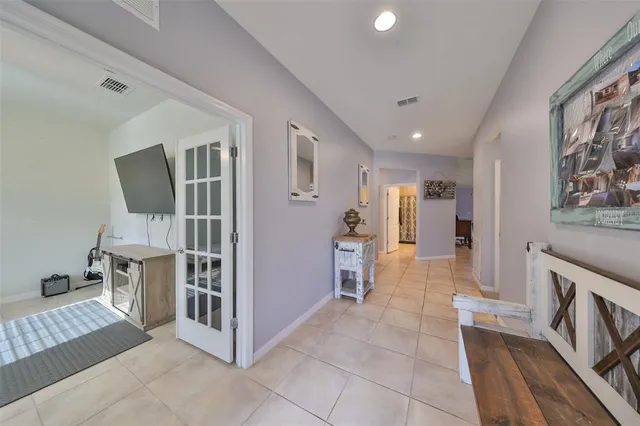 a view of a hallway with furniture and a fireplace