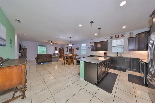 a large kitchen with a large counter top appliances and cabinets