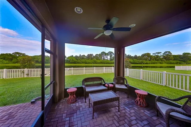 a view of a patio with a table chairs and a backyard