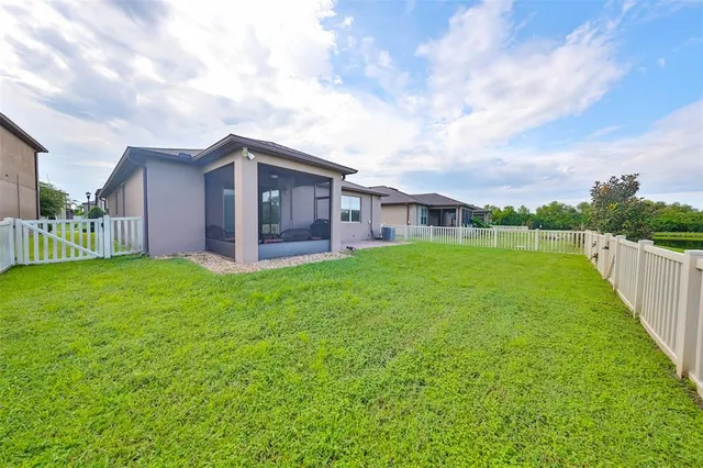 a view of a house with a yard and sitting area