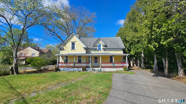 a front view of a house with a yard table and chairs