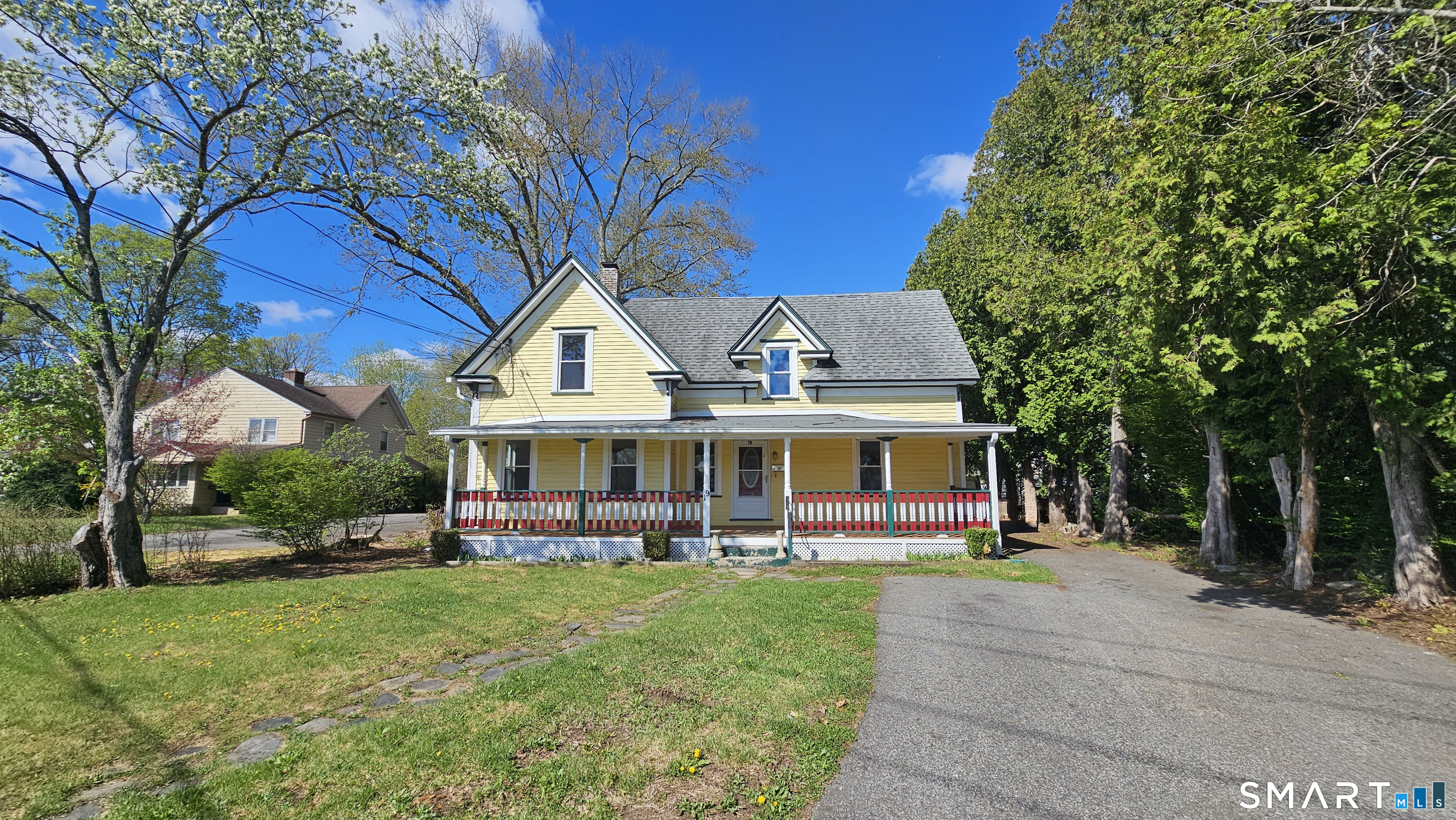 19 Boston Post Road Windham, CT 06226 - Photo 1 of 1 a front view of a house with a yard table and chairs