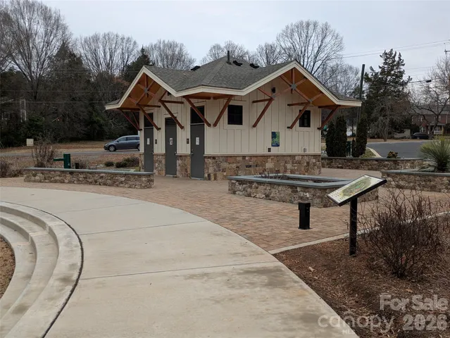 a front view of a house with a yard outdoor seating and mountain view