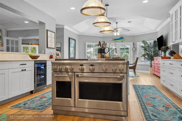 a kitchen with stainless steel appliances granite countertop a refrigerator and a stove top oven