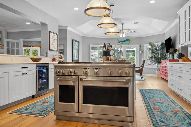 a kitchen with stainless steel appliances granite countertop a refrigerator and a stove top oven
