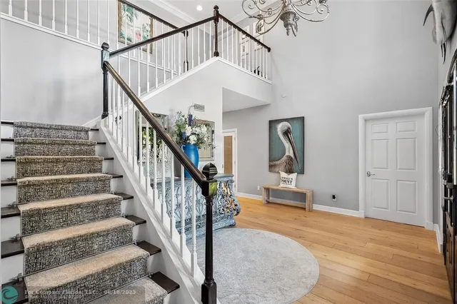 a kitchen with stainless steel appliances granite countertop a stove and a chandelier