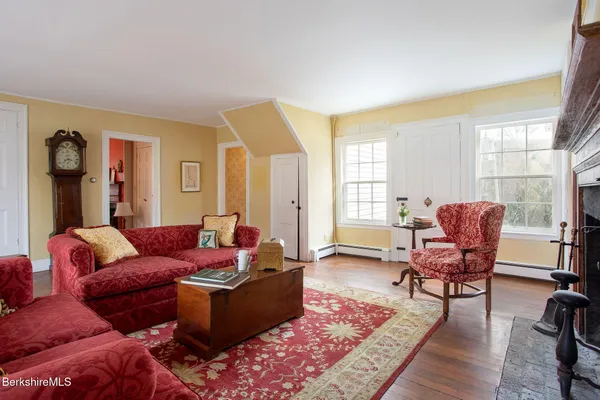 a living room with fireplace furniture and a wooden floor