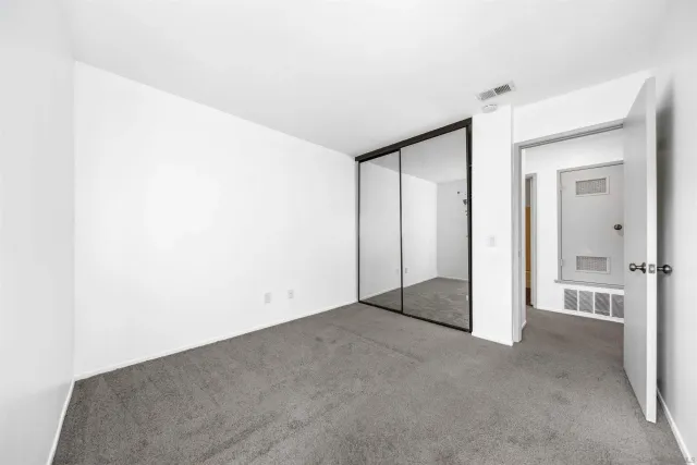 an empty room with closet area