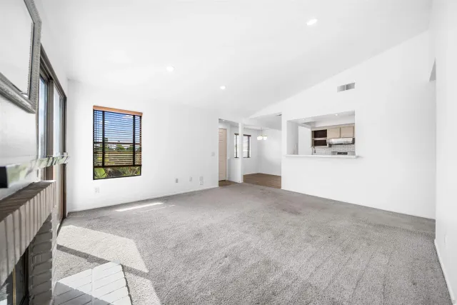 a view of a big room with windows and chandelier