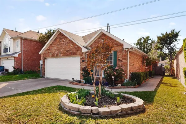 a view of a house with a small yard and plants
