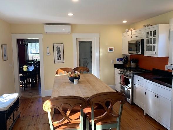251 Tonset Road Orleans, MA 02653 - Photo 20 of 61 a kitchen with a table chairs and wooden floor