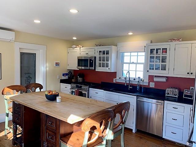 251 Tonset Road Orleans, MA 02653 - Photo 21 of 61 a kitchen with a sink stove and cabinets