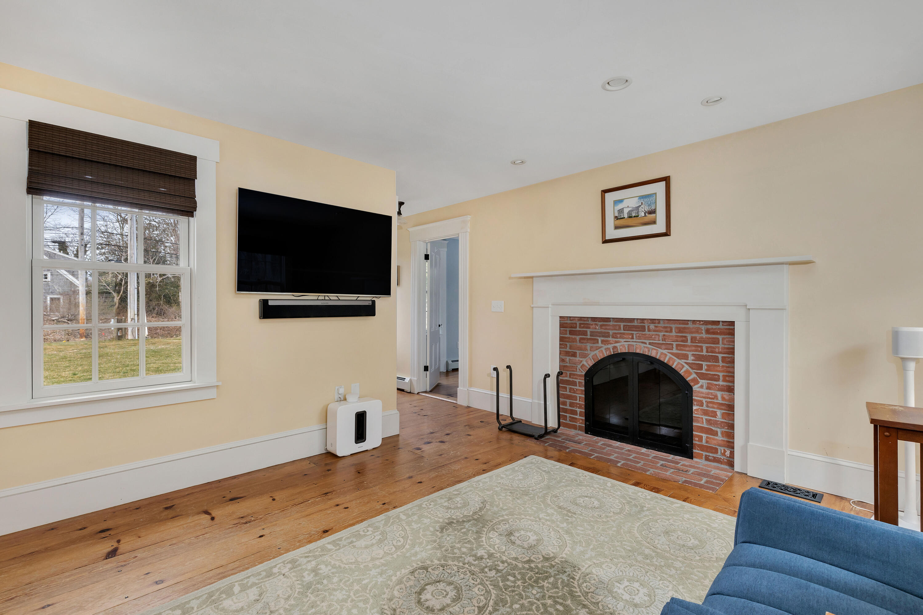 251 Tonset Road Orleans, MA 02653 - Photo 32 of 61 a living room with furniture a flat screen tv and a fireplace