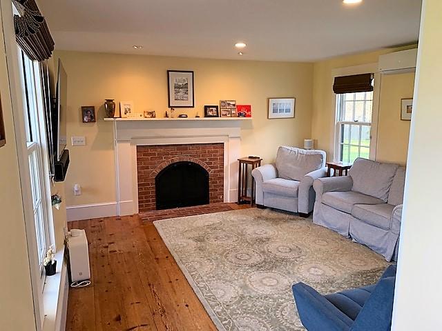 251 Tonset Road Orleans, MA 02653 - Photo 35 of 61 a living room with furniture and a fireplace