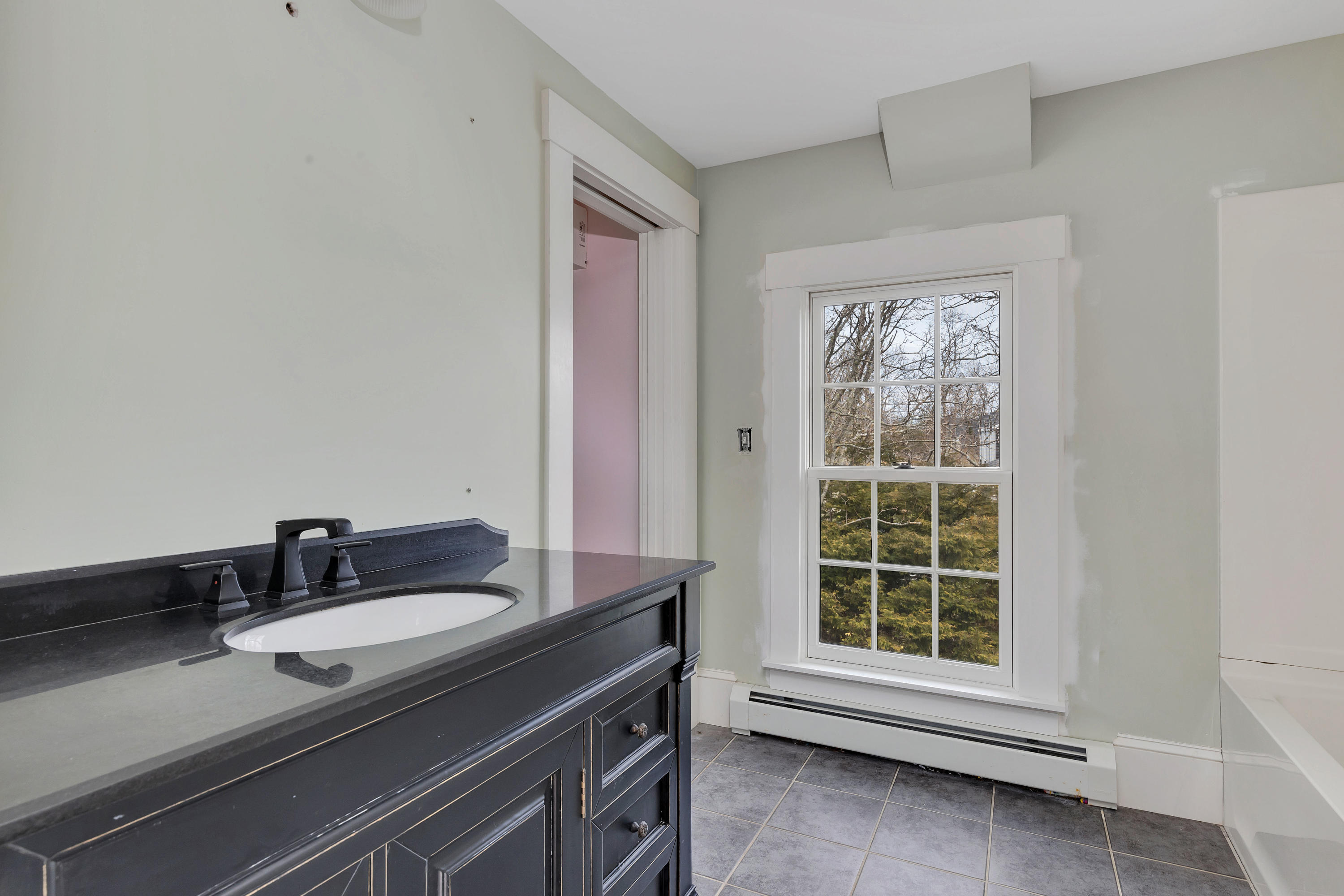 251 Tonset Road Orleans, MA 02653 - Photo 48 of 61 a bathroom with a granite countertop sink a mirror and a window