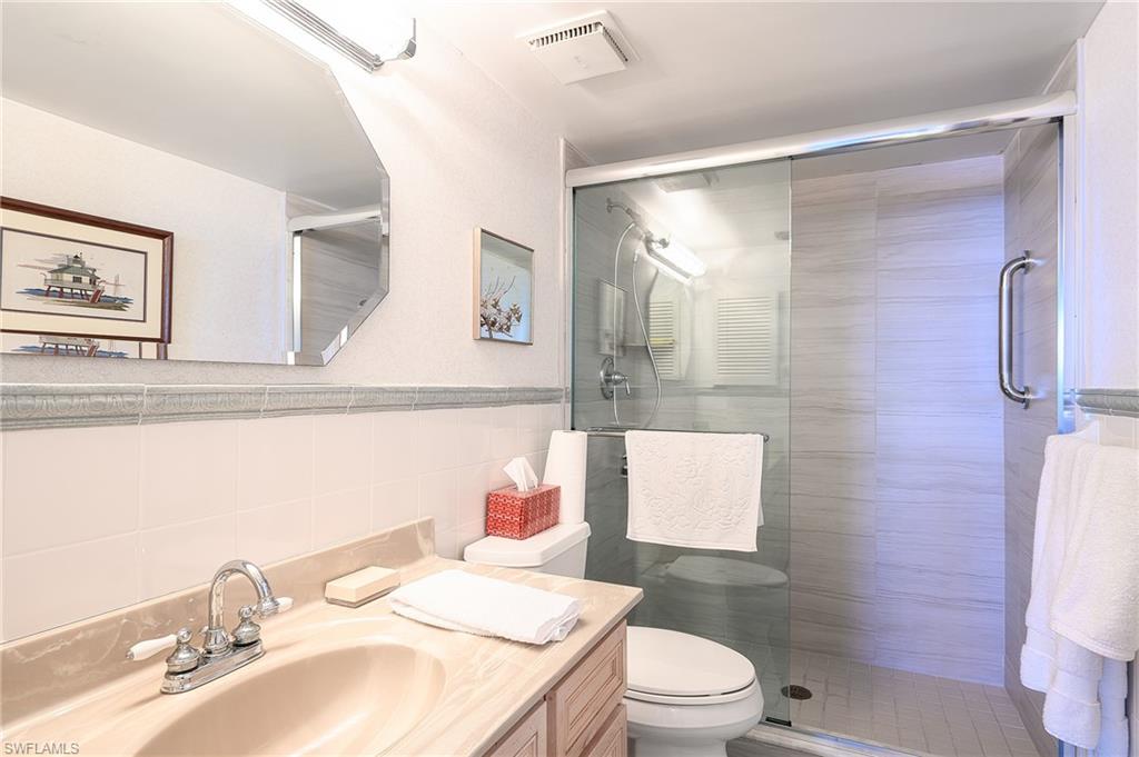 1280 Blue Point Avenue, Unit C30 Naples, FL 34102 - Photo 11 of 24 a bathroom with a sink toilet and shower