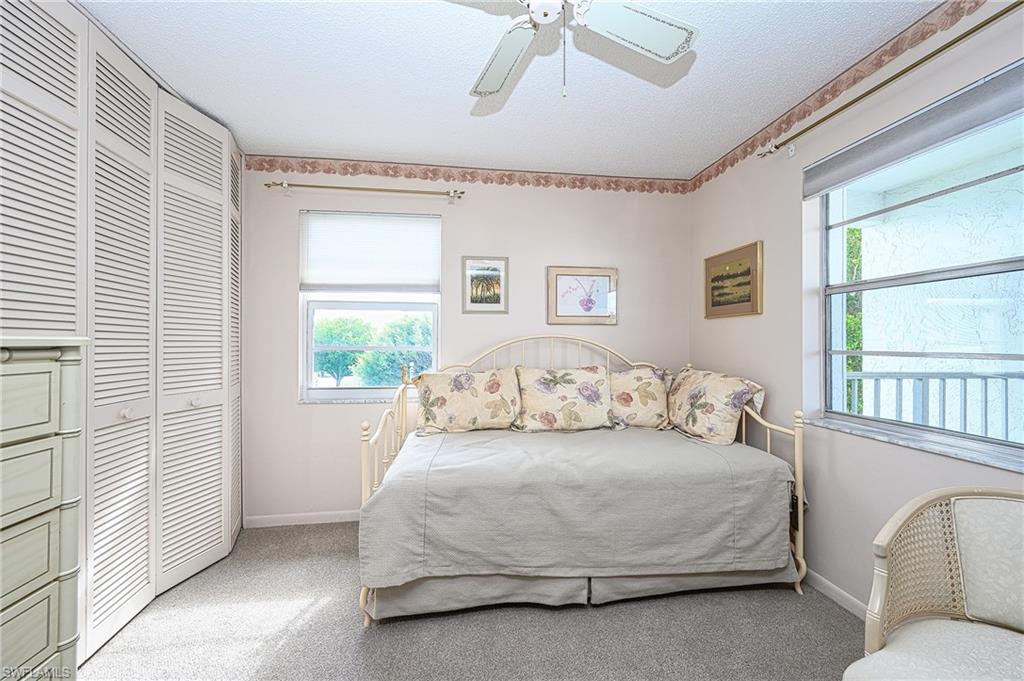 1280 Blue Point Avenue, Unit C30 Naples, FL 34102 - Photo 12 of 24 a living room with a bed furniture and a window