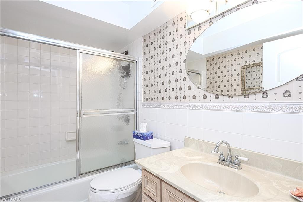 1280 Blue Point Avenue, Unit C30 Naples, FL 34102 - Photo 13 of 24 a bathroom with a sink toilet and shower