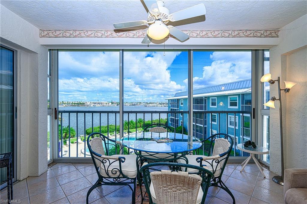 1280 Blue Point Avenue, Unit C30 Naples, FL 34102 - Photo 17 of 24 a view of a dining room with furniture window and outside view