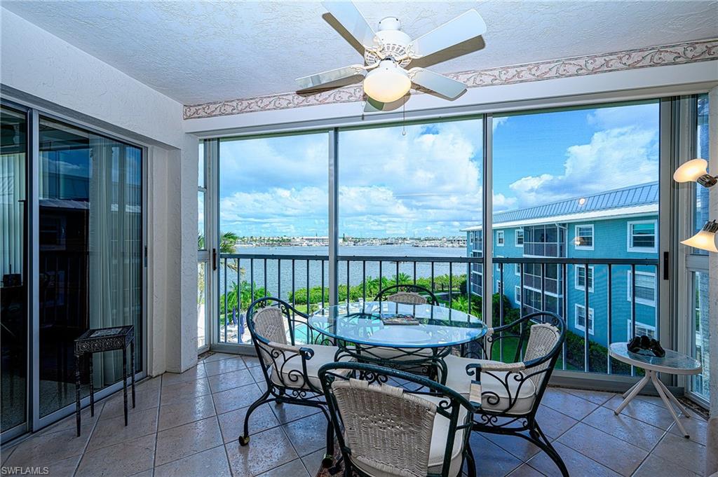 1280 Blue Point Avenue, Unit C30 Naples, FL 34102 - Photo 18 of 24 a dining room with furniture water view and balcony view