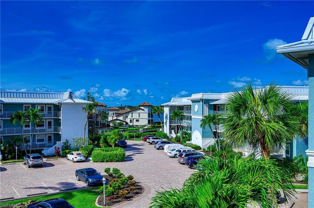 1280 Blue Point Avenue, Unit C30 Naples, FL 34102 - Photo 19 of 24 a view of a house with a yard and potted plants